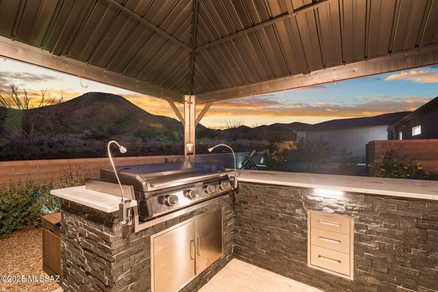10465 E Ocotillo Rim Trl, Vail, AZ 85641 - view of patio / terrace with grilling area, a mountain view, and an outdoor kitchen