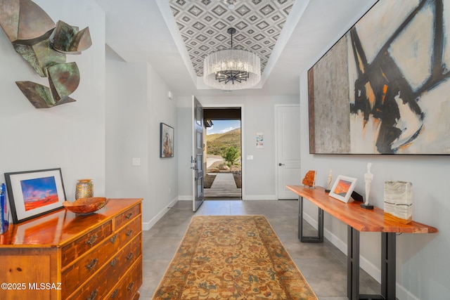 10465 E Ocotillo Rim Trl, Vail, AZ 85641 - foyer featuring a tray ceiling, baseboards, and a chandelier