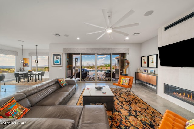 10465 E Ocotillo Rim Trl, Vail, AZ 85641 - tiled living room featuring ceiling fan, recessed lighting, and a tile fireplace