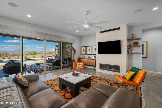 10465 E Ocotillo Rim Trl, Vail, AZ 85641 - living room with a ceiling fan, recessed lighting, a tiled fireplace, and baseboards