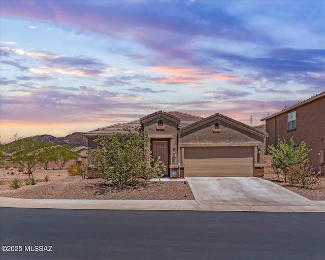 10094 N Cardon Grande Trl, Marana, AZ 85653 - view of front of home featuring concrete driveway, an attached garage, stone siding, a tile roof, and stucco siding