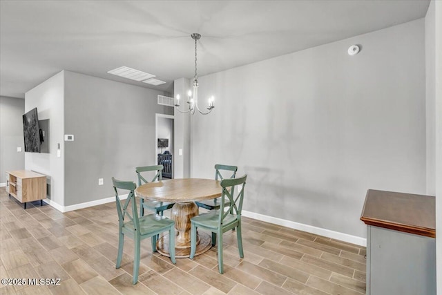 10094 N Cardon Grande Trl, Marana, AZ 85653 - dining space with light wood-style flooring, a chandelier, and baseboards