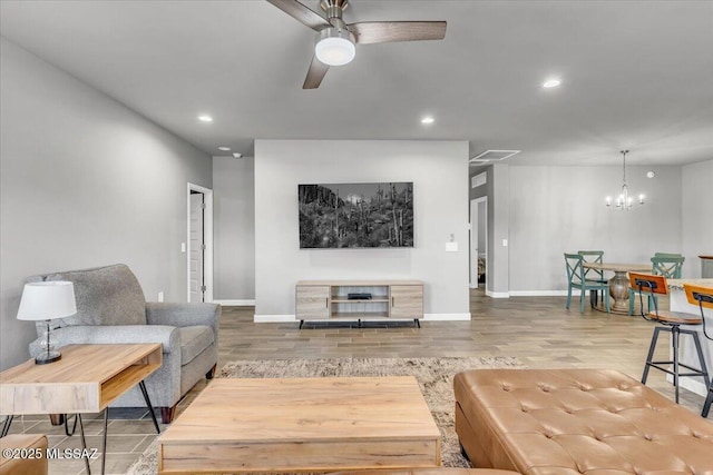 10094 N Cardon Grande Trl, Marana, AZ 85653 - living room featuring recessed lighting, a chandelier, baseboards, wood finished floors, and a ceiling fan