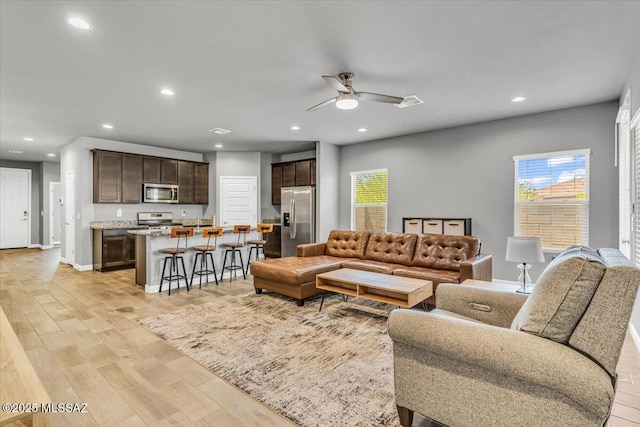 10094 N Cardon Grande Trl, Marana, AZ 85653 - living room featuring light wood-type flooring, ceiling fan, healthy amount of natural light, recessed lighting, and baseboards