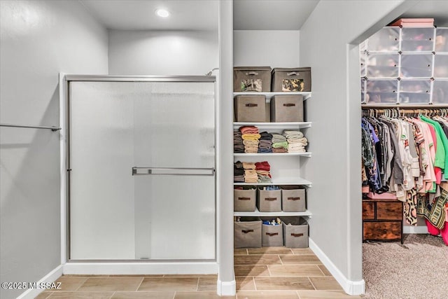 10094 N Cardon Grande Trl, Marana, AZ 85653 - full bathroom with a shower stall, baseboards, and a walk in closet