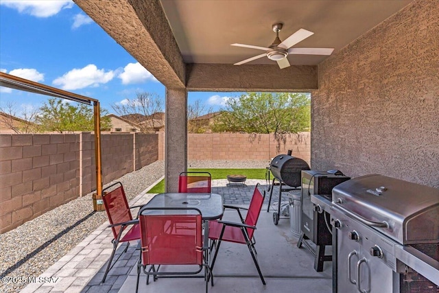 10094 N Cardon Grande Trl, Marana, AZ 85653 - view of patio featuring outdoor dining space, a ceiling fan, a fenced backyard, and area for grilling