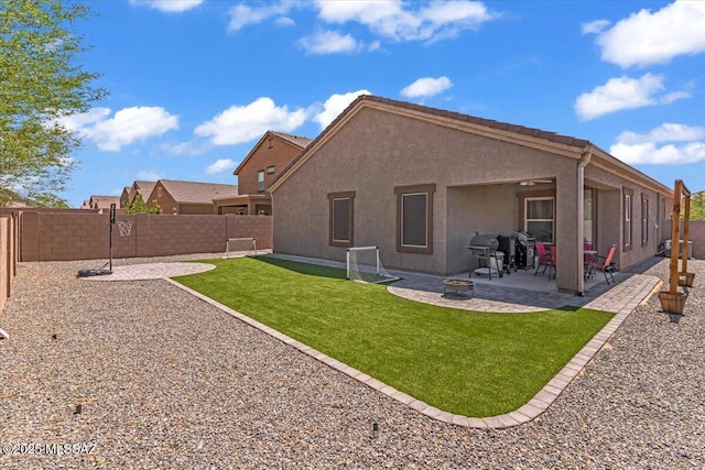 10094 N Cardon Grande Trl, Marana, AZ 85653 - back of property with an outdoor fire pit, stucco siding, and a patio area