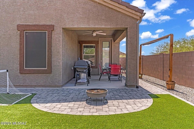 10094 N Cardon Grande Trl, Marana, AZ 85653 - view of patio / terrace with an outdoor fire pit, a fenced backyard, a ceiling fan, and outdoor dining space