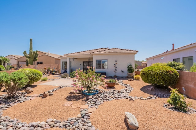 2337 S Via Vespucci, Green Valley, AZ 85614 - back of property featuring a tiled roof, fence, stucco siding, and a patio