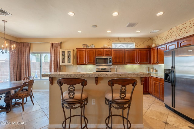 2337 S Via Vespucci, Green Valley, AZ 85614 - kitchen with appliances with stainless steel finishes, a kitchen bar, recessed lighting, a chandelier, and glass insert cabinets