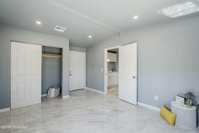 unfurnished bedroom with light marble finish flooring, baseboards, recessed lighting, and a closet