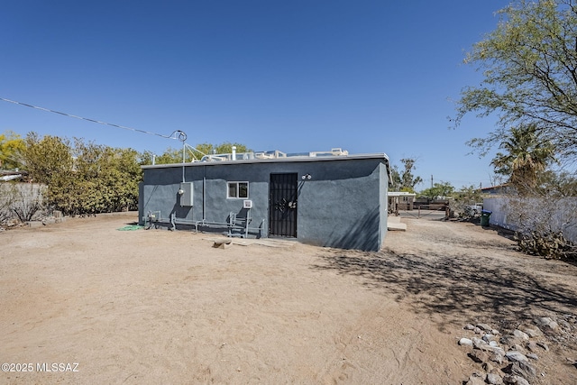 back of property with stucco siding
