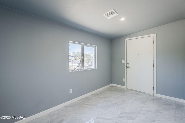 spare room featuring light marble finish flooring, baseboards, and recessed lighting