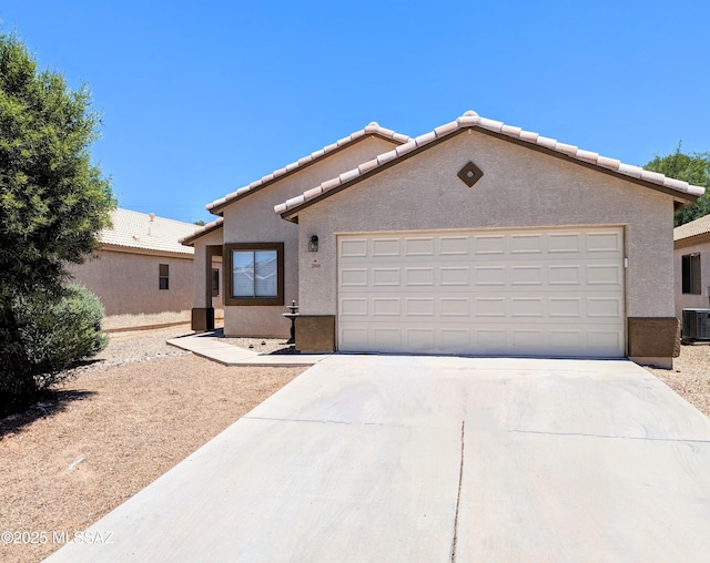 2866 W Medallion Dr, Tucson, AZ 85741 - view of front of property with concrete driveway, an attached garage, stucco siding, central AC unit, and a tile roof