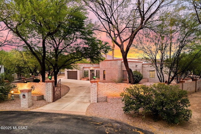 view of property's community with concrete driveway and fence