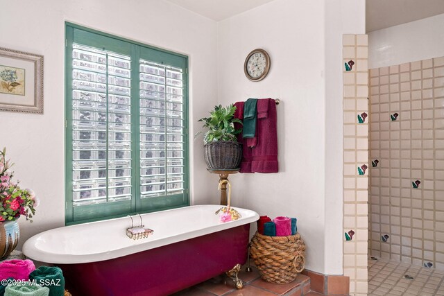 bathroom with tiled shower and a soaking tub