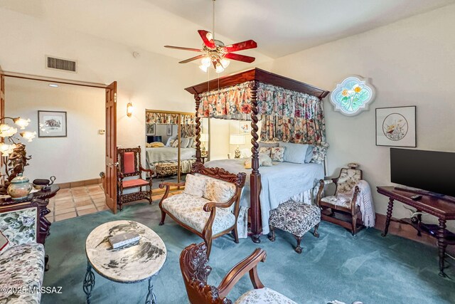 bedroom featuring lofted ceiling, baseboards, tile patterned floors, and ceiling fan