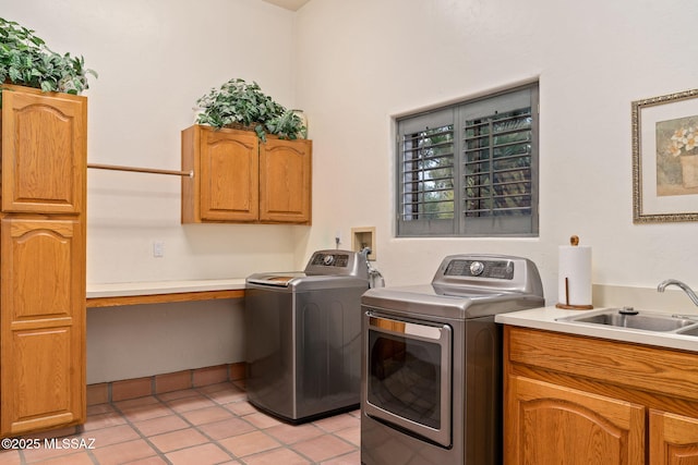 washroom featuring washer and clothes dryer, cabinet space, and light tile patterned floors