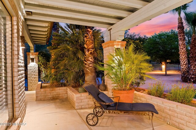 view of patio terrace at dusk