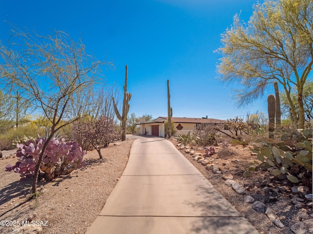 5825 N Camino Miraval Dr, Tucson, AZ 85718 - view of front facade featuring a garage, concrete driveway, and stucco siding