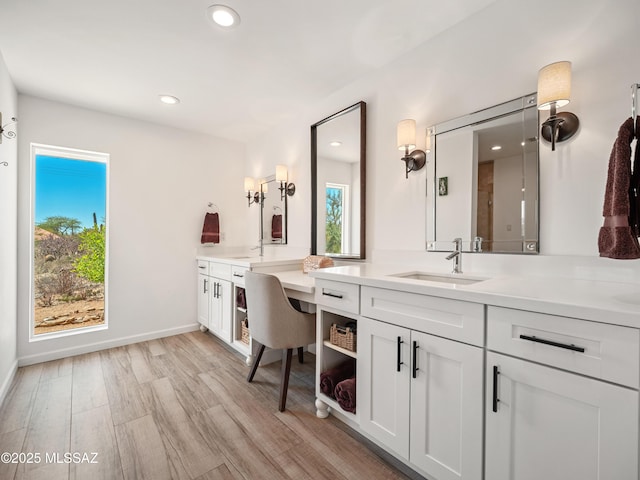 5825 N Camino Miraval Dr, Tucson, AZ 85718 - bathroom with wood finished floors, vanity, recessed lighting, and baseboards