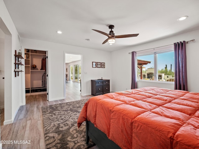 5825 N Camino Miraval Dr, Tucson, AZ 85718 - bedroom featuring light wood-type flooring, recessed lighting, a spacious closet, baseboards, and a ceiling fan