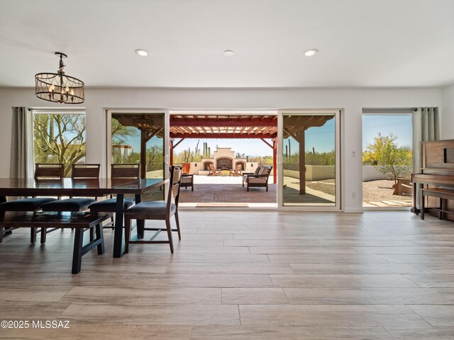 5825 N Camino Miraval Dr, Tucson, AZ 85718 - dining room with light wood-type flooring, recessed lighting, and a chandelier