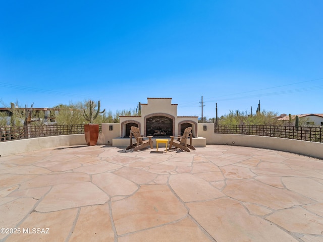 5825 N Camino Miraval Dr, Tucson, AZ 85718 - view of patio with an outdoor fireplace and fence