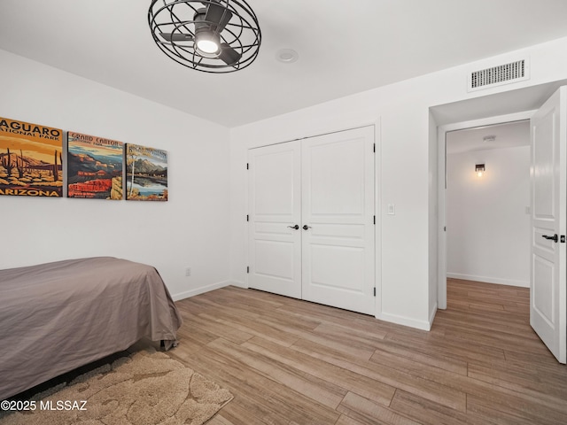 5825 N Camino Miraval Dr, Tucson, AZ 85718 - bedroom featuring light wood-style floors, baseboards, and a closet