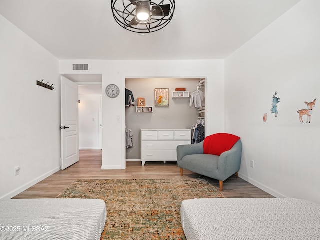 5825 N Camino Miraval Dr, Tucson, AZ 85718 - bedroom with wood finished floors, baseboards, a walk in closet, and a closet
