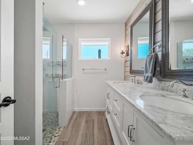 5825 N Camino Miraval Dr, Tucson, AZ 85718 - full bath featuring plenty of natural light, a shower stall, wood finished floors, double vanity, and recessed lighting