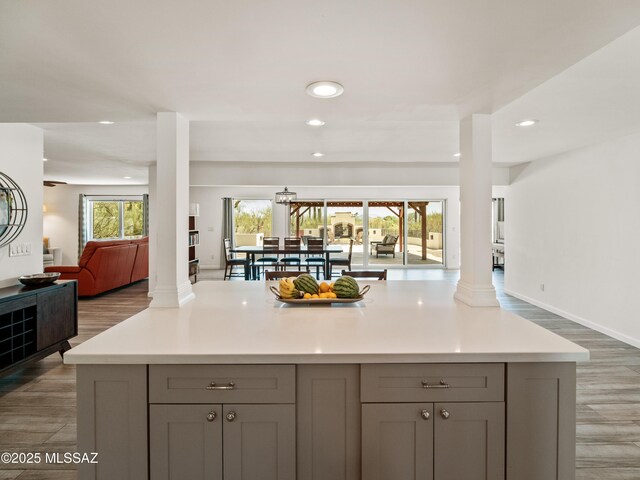 5825 N Camino Miraval Dr, Tucson, AZ 85718 - kitchen with open floor plan, gray cabinets, recessed lighting, wood finished floors, and light countertops