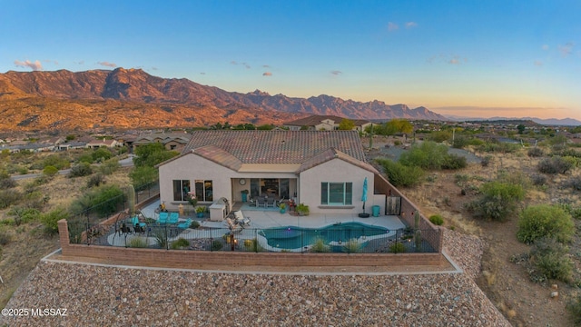 66450 E Sundance Pl, Saddlebrooke, AZ 85739 - rear view of house featuring a tile roof, a fenced backyard, and a mountain view