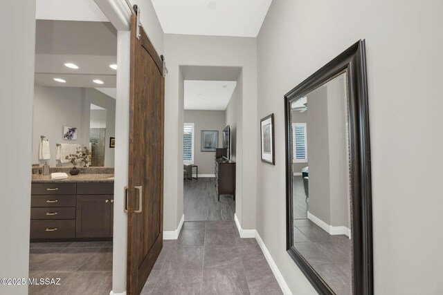 66450 E Sundance Pl, Saddlebrooke, AZ 85739 - hallway with a barn door and baseboards
