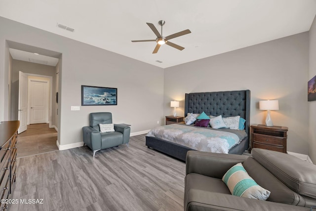 66450 E Sundance Pl, Saddlebrooke, AZ 85739 - bedroom with wood finished floors, baseboards, and a ceiling fan