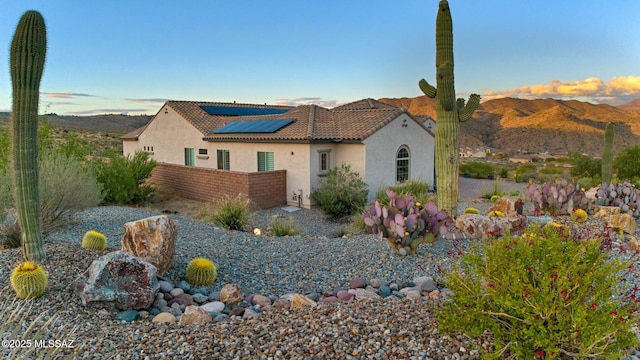 66450 E Sundance Pl, Saddlebrooke, AZ 85739 - mediterranean / spanish house featuring stucco siding, solar panels, a tiled roof, and a mountain view