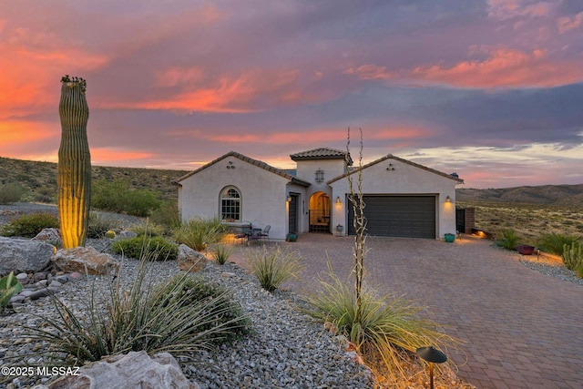 66450 E Sundance Pl, Saddlebrooke, AZ 85739 - mediterranean / spanish-style home with stucco siding, an attached garage, and decorative driveway