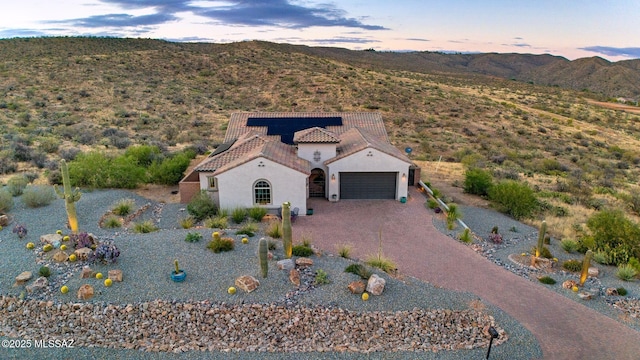 66450 E Sundance Pl, Saddlebrooke, AZ 85739 - view of front of property featuring stucco siding, an attached garage, a tile roof, a mountain view, and driveway