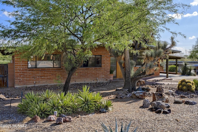 6714 E Topke St, Tucson, AZ 85715 - view of property exterior featuring brick siding and fence