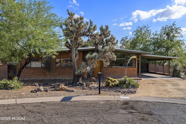 6714 E Topke St, Tucson, AZ 85715 - view of front of property with concrete driveway, an attached carport, and brick siding