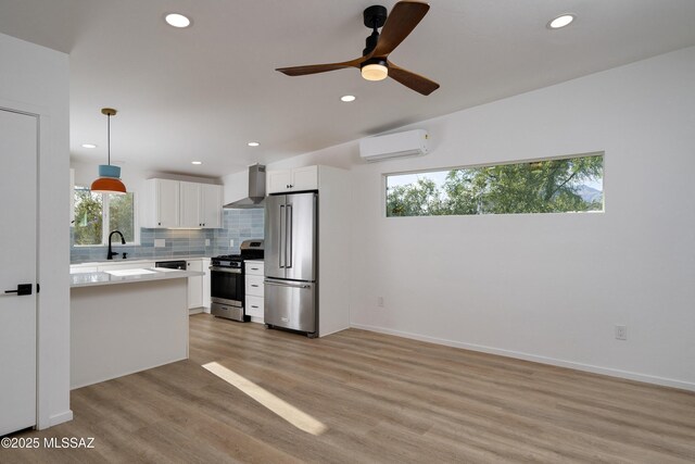 6714 E Topke St, Tucson, AZ 85715 - kitchen with stainless steel appliances, wall chimney range hood, a wall mounted air conditioner, light countertops, and recessed lighting