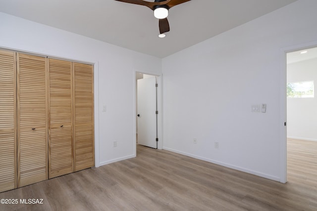 6714 E Topke St, Tucson, AZ 85715 - unfurnished bedroom with light wood-type flooring, baseboards, a closet, and a ceiling fan