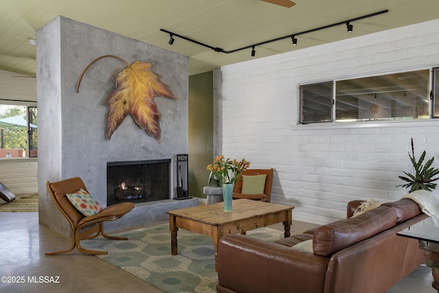 6714 E Topke St, Tucson, AZ 85715 - living area with track lighting, finished concrete floors, and a fireplace with raised hearth
