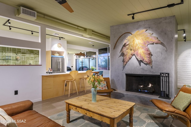 6714 E Topke St, Tucson, AZ 85715 - living room featuring track lighting, a high end fireplace, and wooden ceiling