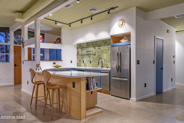 6714 E Topke St, Tucson, AZ 85715 - kitchen with stainless steel appliances, concrete floors, track lighting, a sink, and baseboards