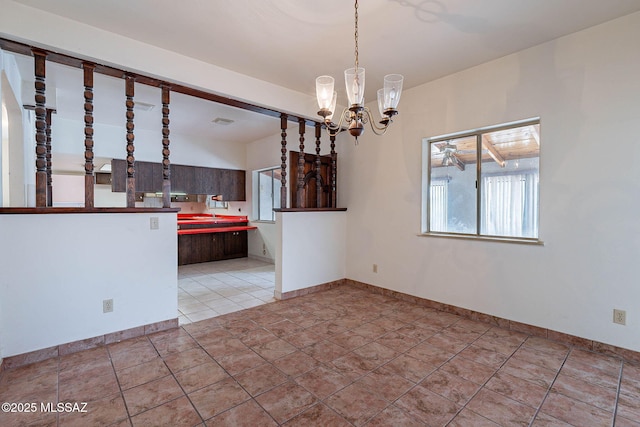 3531 W Goret Rd, Tucson, AZ 85745 - unfurnished dining area featuring a chandelier and baseboards
