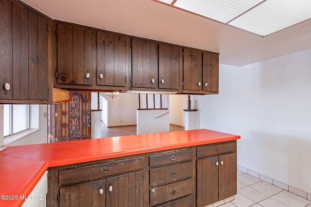 3531 W Goret Rd, Tucson, AZ 85745 - kitchen featuring light tile patterned floors, dark brown cabinets, and light countertops