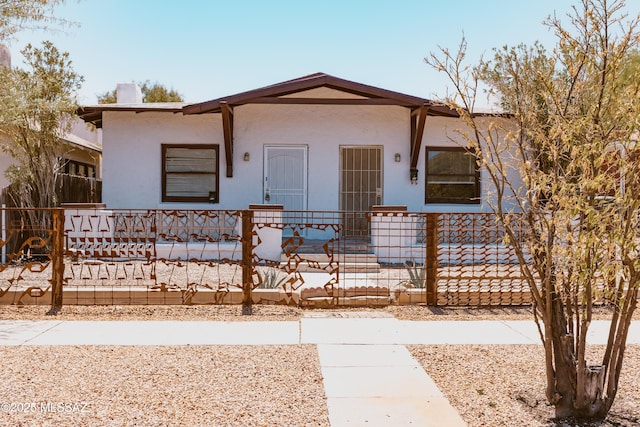 616 E 8th St, Tucson, AZ 85705 - view of front of house with stucco siding and a fenced front yard