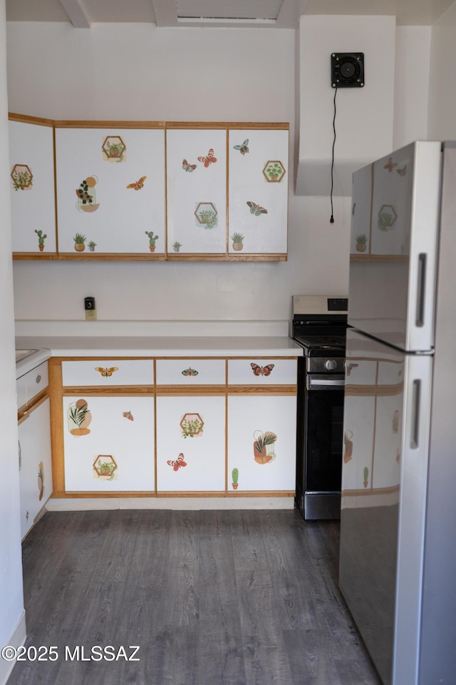 616 E 8th St, Tucson, AZ 85705 - kitchen featuring freestanding refrigerator, gas range, dark wood finished floors, light countertops, and white cabinets