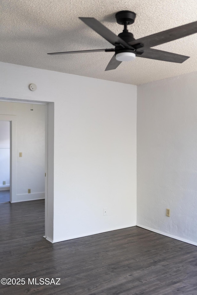 616 E 8th St, Tucson, AZ 85705 - empty room with ceiling fan, dark wood-style flooring, a smoke detector, a textured ceiling, and baseboards